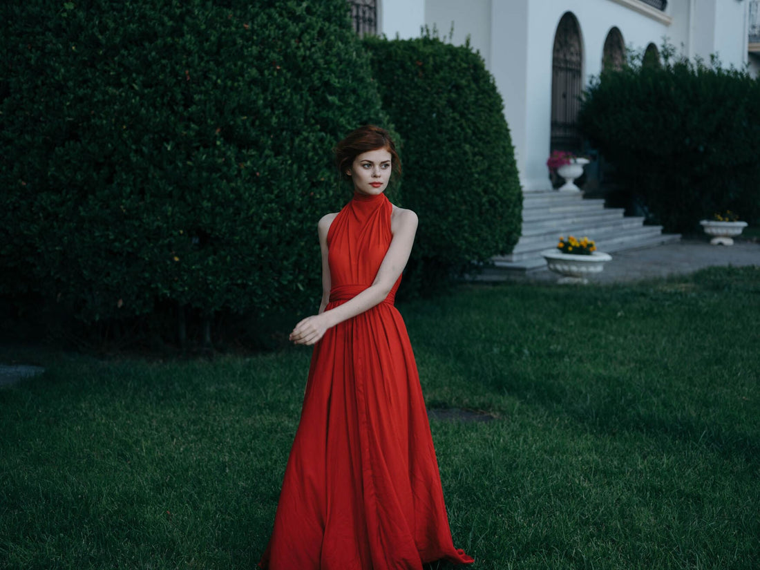 Featured image what to wear to a fall wedding, Woman in luxury red dress walk outdoors Masquerade gothic style