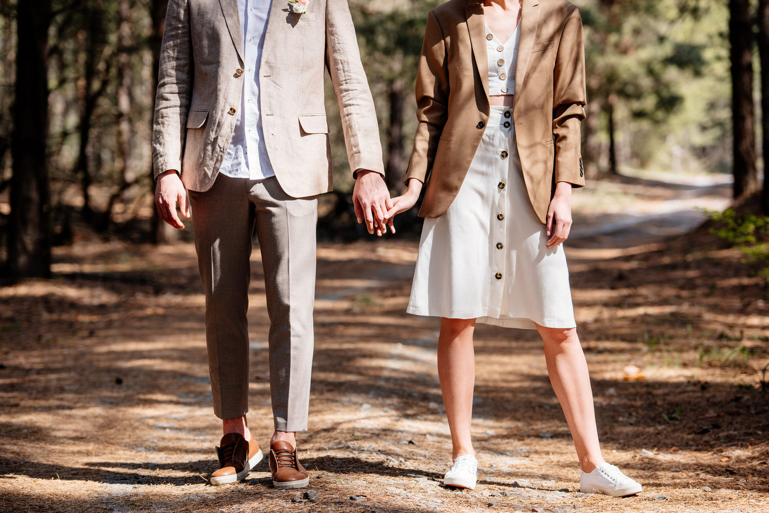 Courthouse Wedding Attire image, cropped view of fashionable couple holding hands in forest