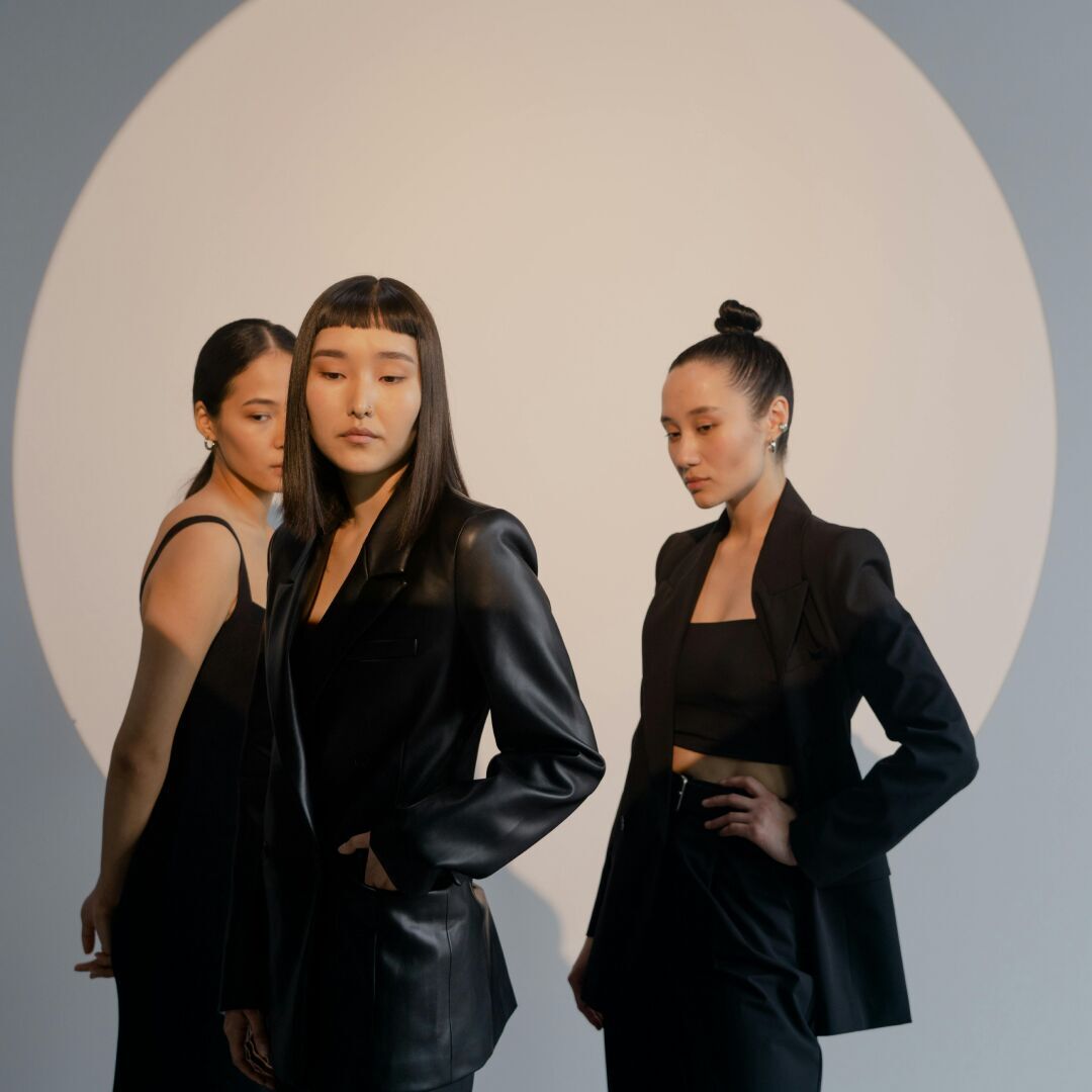 3 women with black outfits