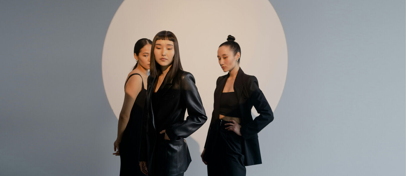 3 women with black outfits